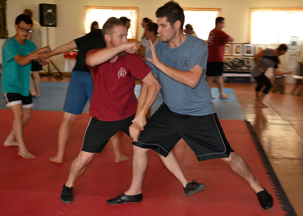 two students practicing martials arts applications